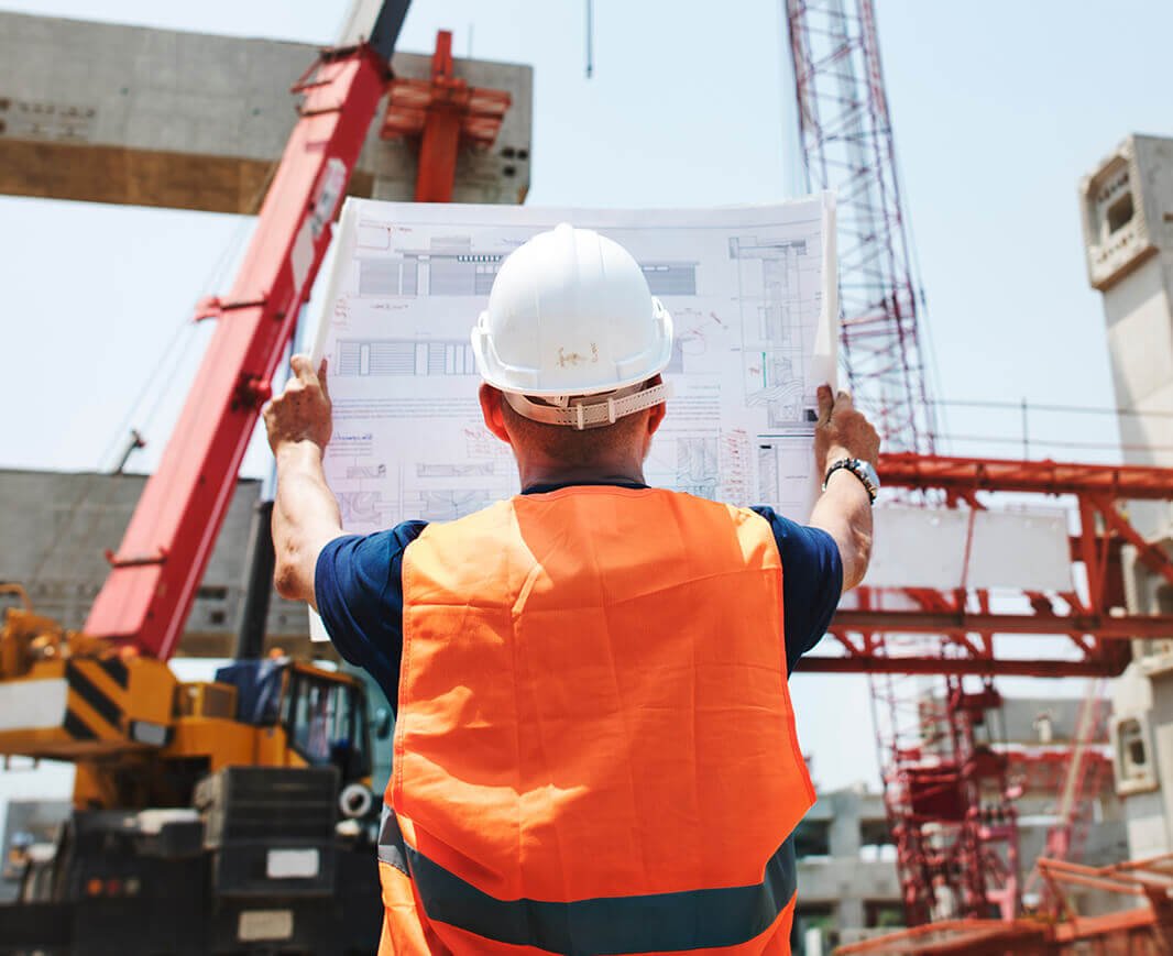 Engineer reviewing blueprint on a construction site