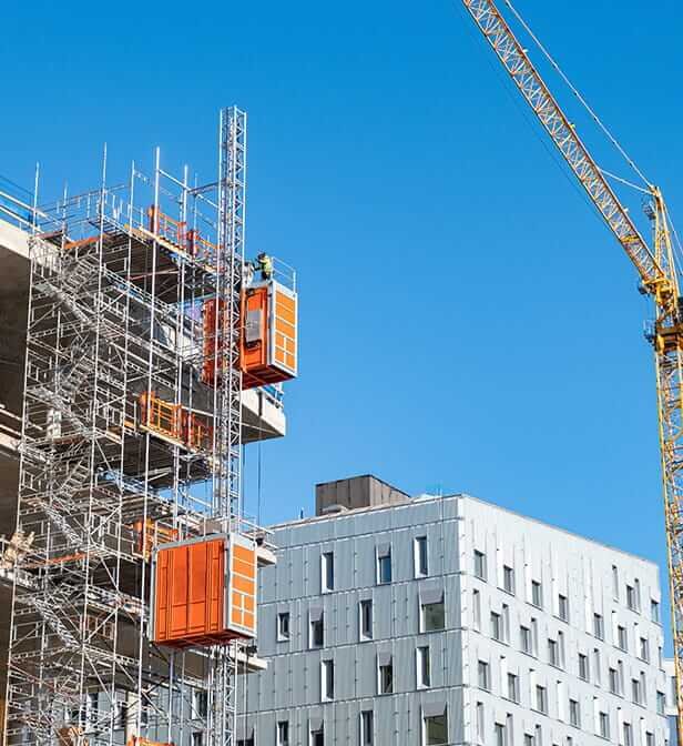 Crane and building works under a clear sky